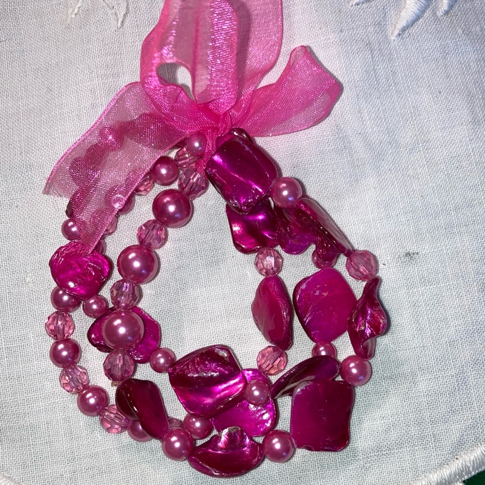 Set of 3 stretch bracelets with pink beads tied w/ribbon or separately. $12